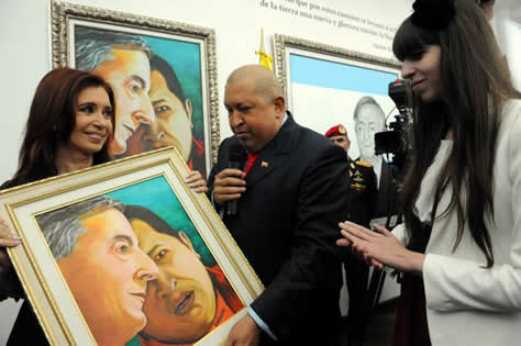 Hugo Chavez and Cristina Kirchner view a painting of the faces of Nestor Kirchner and Chavez 