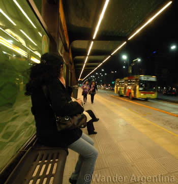A woman waits for the bus at a new Metrobus stop on 9 de Julio 
