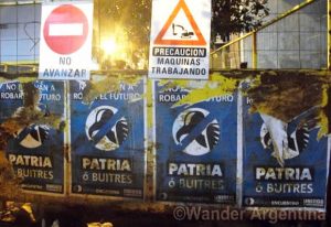 Posters on the streets of Buenos Aires say 'Homeland or Vultures'